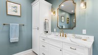 Blue primary bathroom remodel with vanity and storage tower