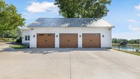 White garage addition with brown garage doors