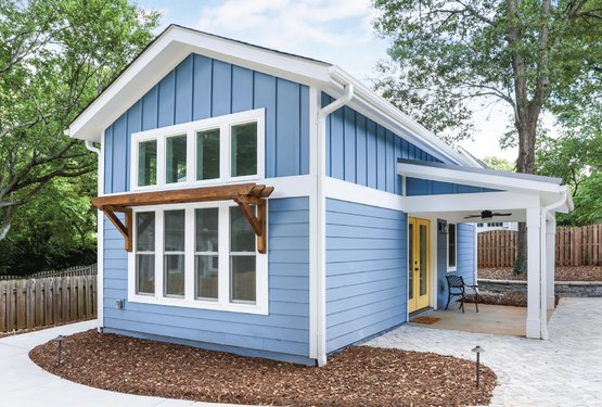 Tiny blue custom home with yellow doors