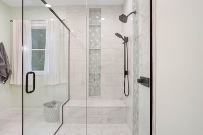 White and mint bathroom with green tile shower