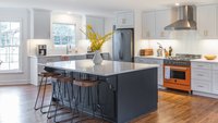 Traditional kitchen with blue island and orange appliances