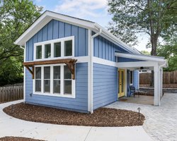 Blue tiny house with yellow doors