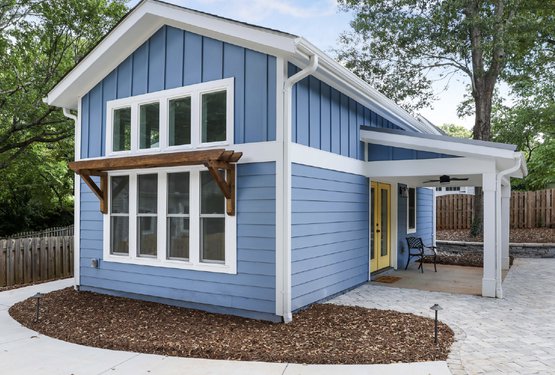 Blue tiny house with yellow doors