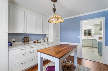Aleutian blue prep kitchen with white cabinetry and prep table