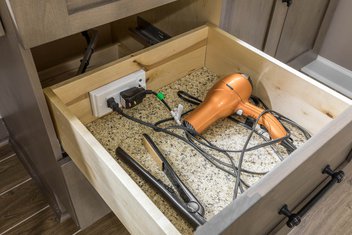 Open drawer with cosmetic heat tools