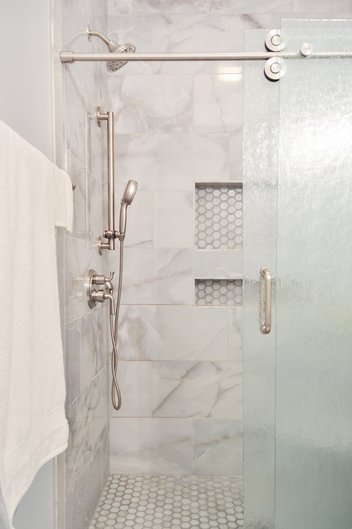 Gray tiled shower with sliding glass door