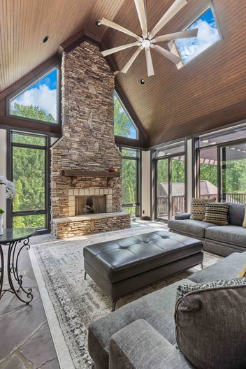 Second story sunroom looking into backyard with pool