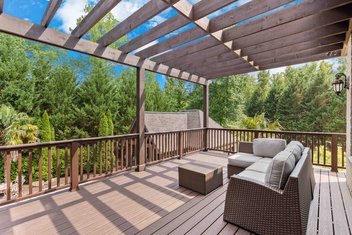 Brown second story custom deck with pergola