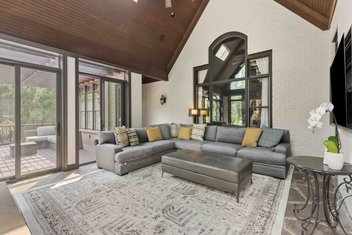 Sunroom with couch, glass doors and decks outside