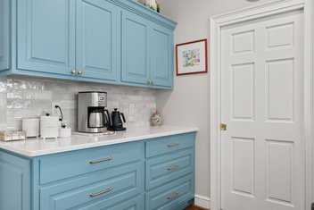 Coffee bar with blue cabinets and white countertop