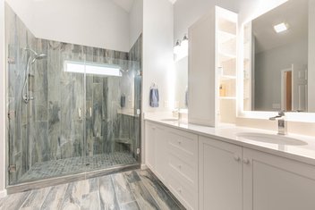Bathroom with gray double shower and white vanity
