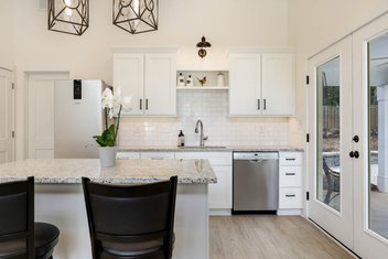 Simple small white guest house kitchen