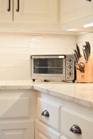 White kitchen with granite countertops