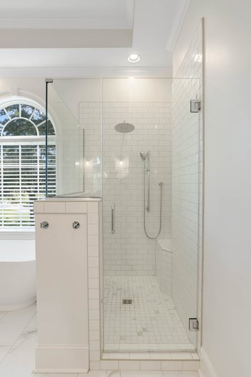 Fully glass shower with white subway tile
