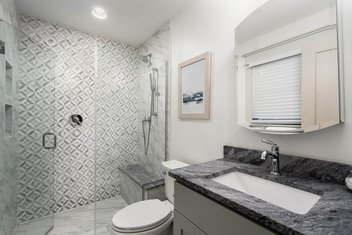 Gray and white bathroom with tiled shower