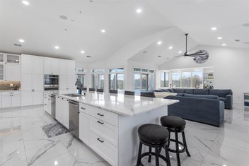 Kitchen with large island and white floor, cabinets and countertop