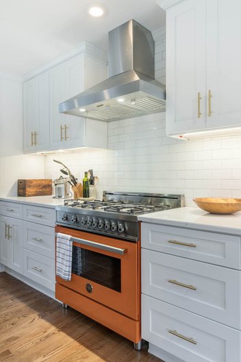 White kitchen with orange range