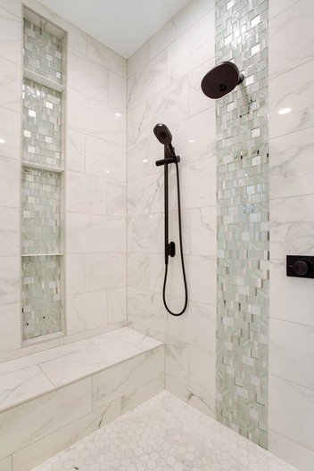Tile details in white and green tiled glass shower