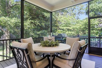 Screened porch with table and chairs