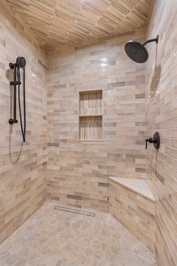 Neutral tiled shower with several custom features