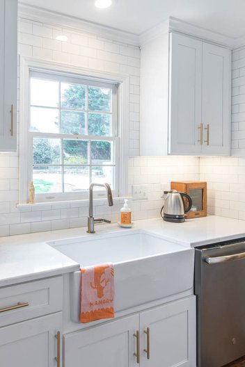 White kitchen sink with window and white tile