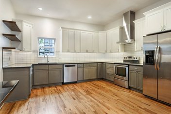Simple white and navy kitchen with wood floors