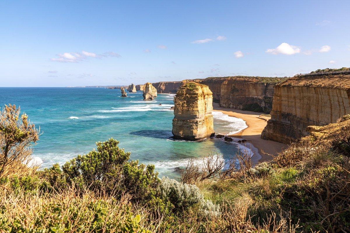 The Twelve Apostles limestone stacks and golden cliffs above a beach on Victoria's Great Ocean Road, Australia