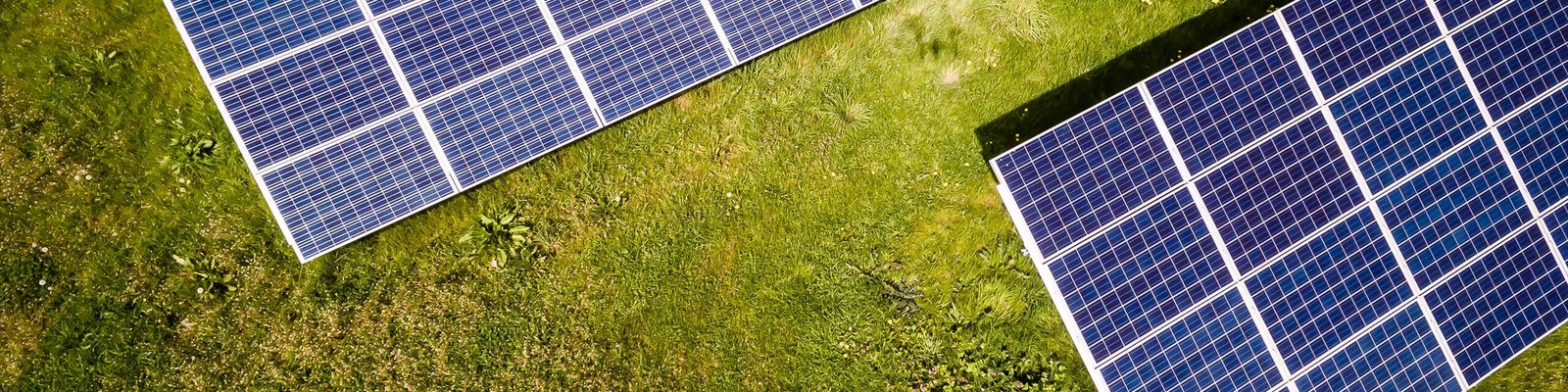 Overhead view of solar arrays on a grassy field