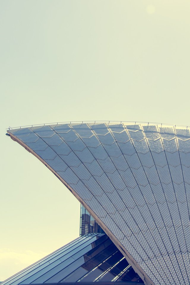 Curved, cantilevered roof with panels