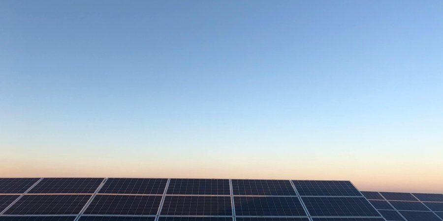 Solar panels, dusk sky