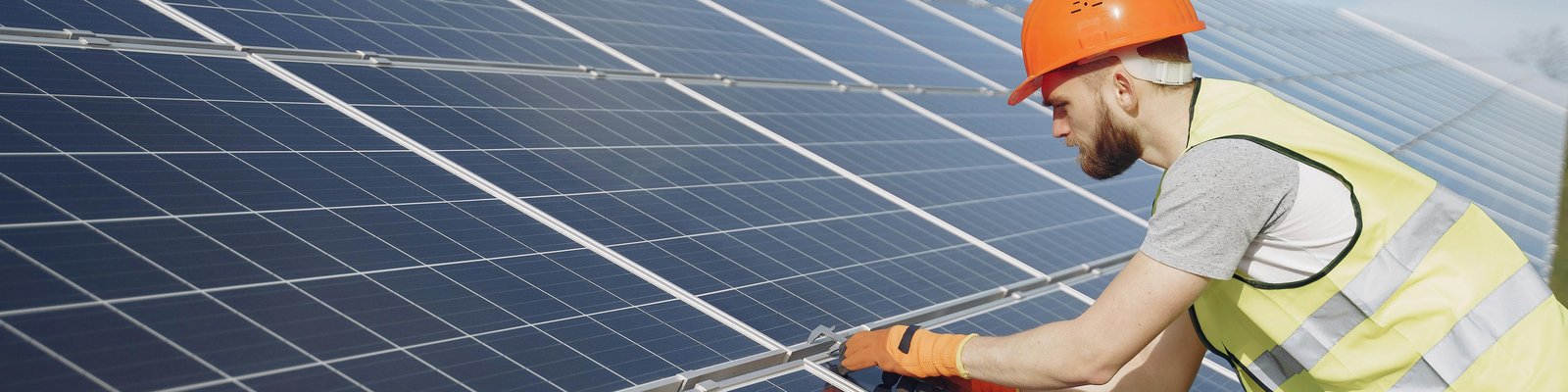 Worker installing solar panels
