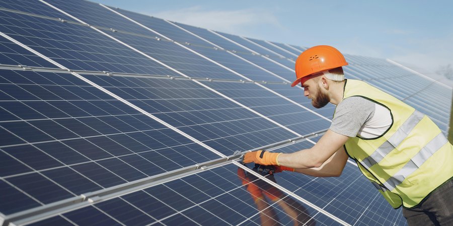 Worker installing solar panels