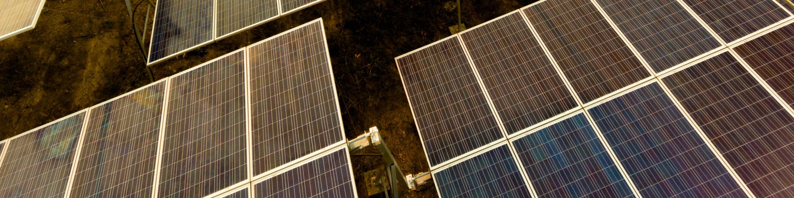 A moderate-sized array of solar panels, sunset light