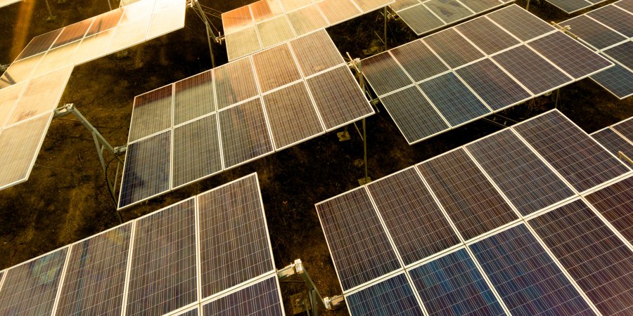 A moderate-sized array of solar panels, sunset light