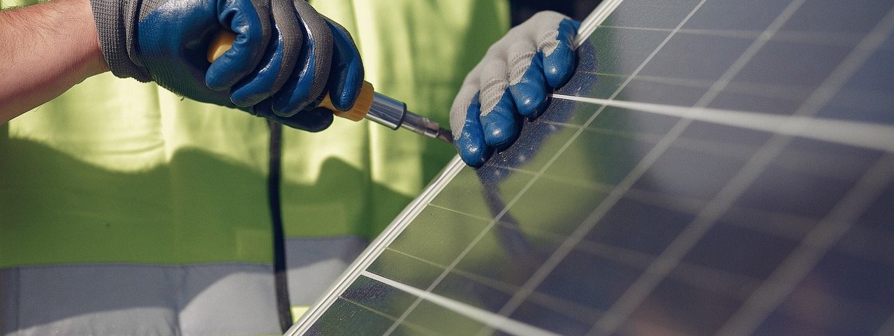 Closeup of worker, hands, working on panel