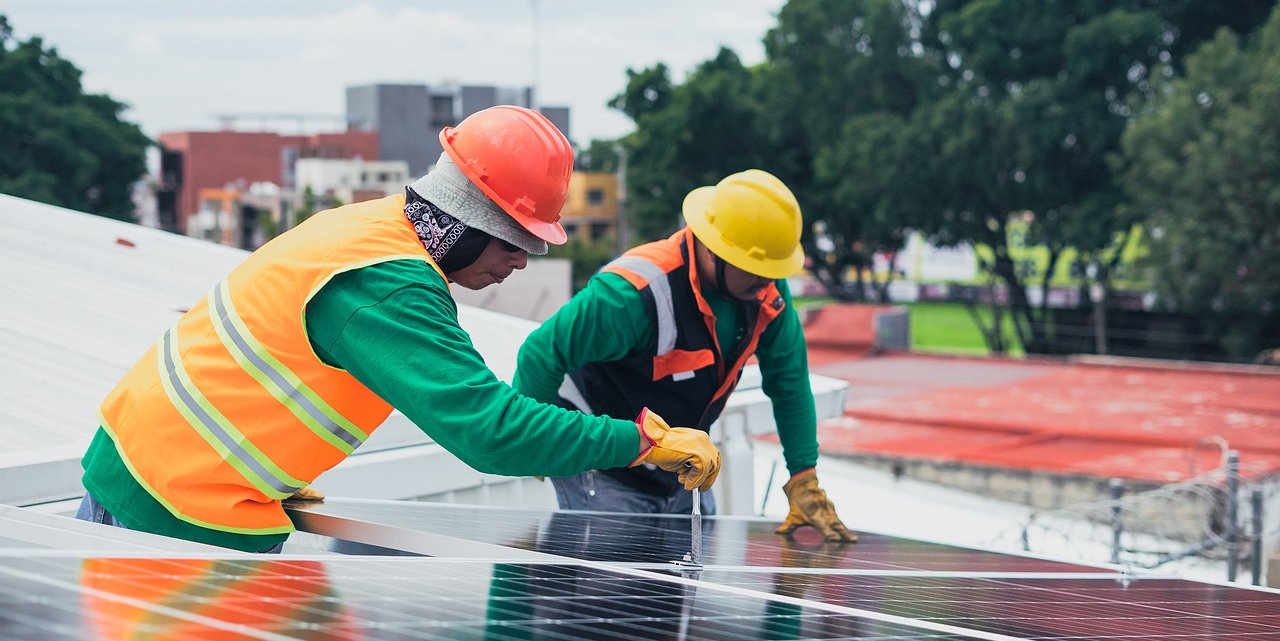 Workers installing solar panels