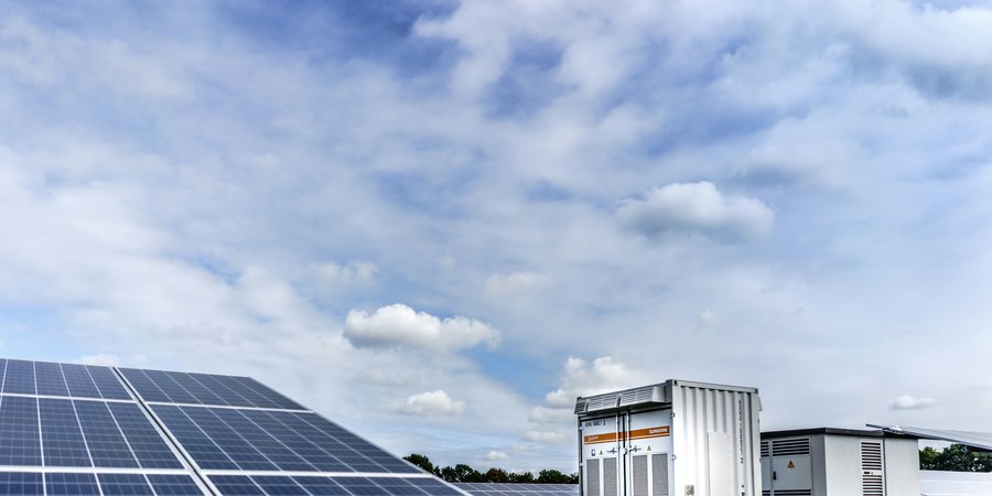 white and black solar panels under white clouds and blue sky during daytime