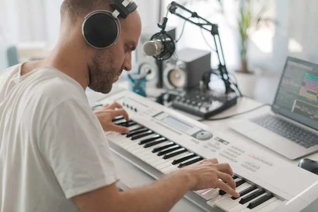 musician-recording-keyboard-with-a-laptop
