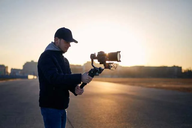 filmmaker outside on location with dslr camera on gimbal