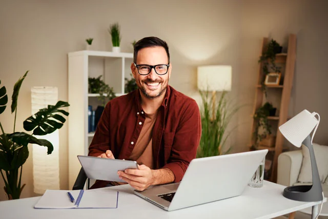 young-man-works-from-home-at-a-desk-with-a-tablet-2023-03-28-19-46-28-utc