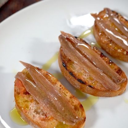 Anchovies toast with rubbed tomato. Spanish Tapa