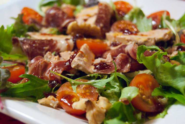 Gourmet summer salad with foie gras and Iberian ham