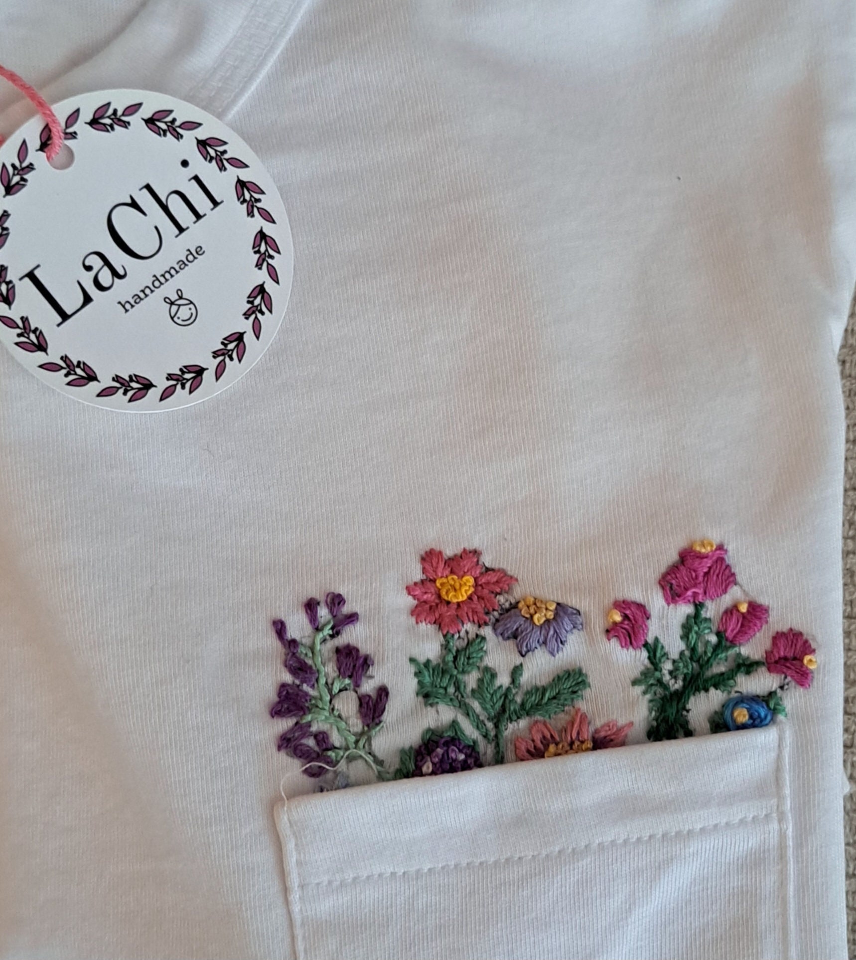 Hand Embroidered T-shirt With Colorful Flowers That Peek Out From The Pocket