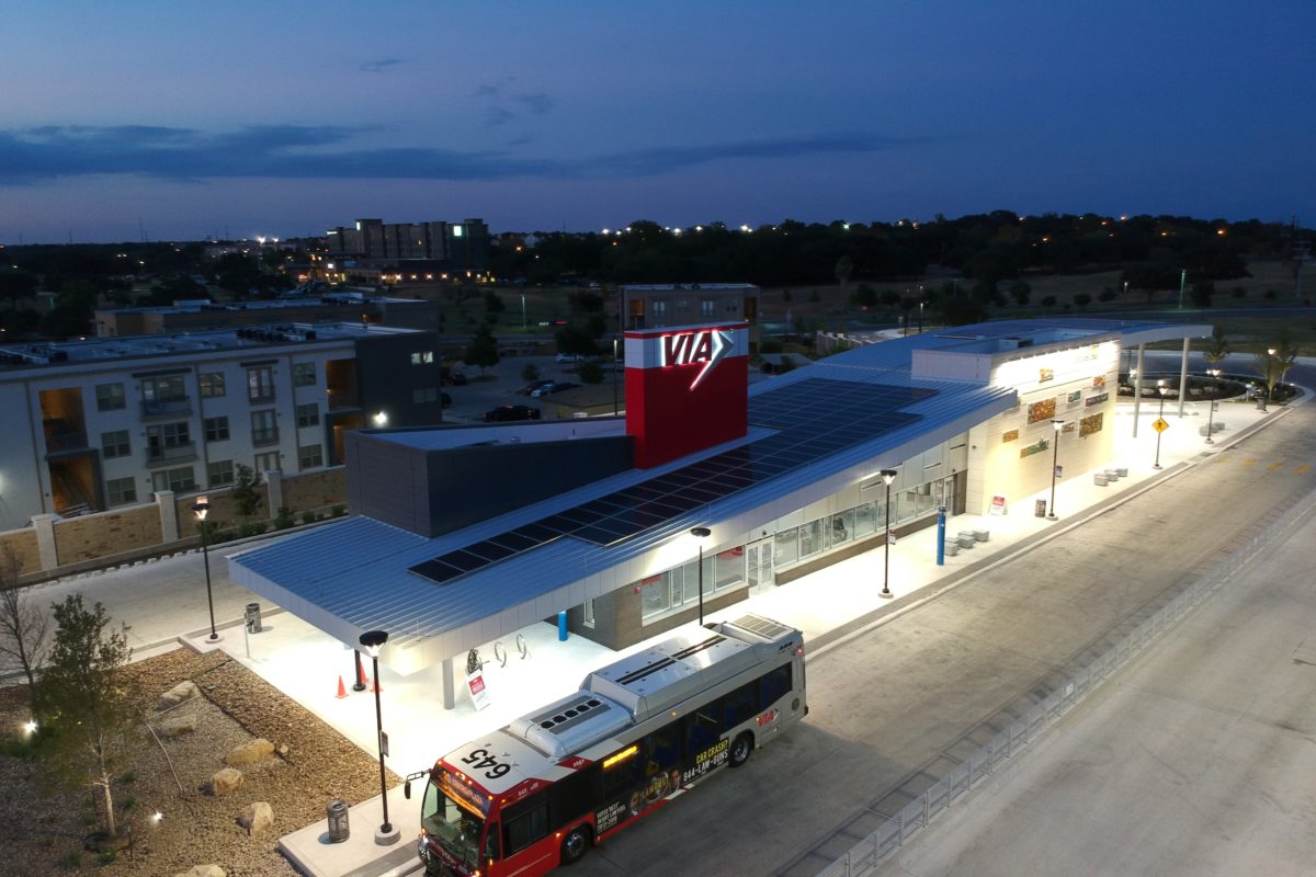 Nighttime Aerial View of Brooks City Base Transit Center With Bus in Front