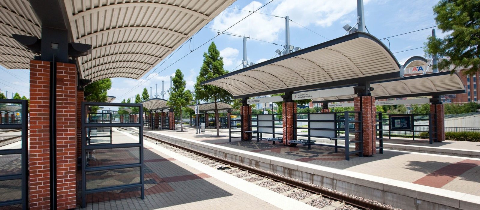 Side view of train rails and canopied stops at the Victory Station