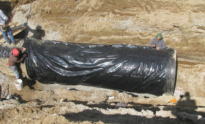KAI 360 Construction Services placing a pipe and tarp for the Lower Meramec project