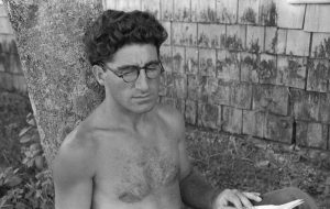 Bare chested man seated