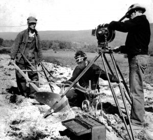 Camera, two camera crew, farmer with plow