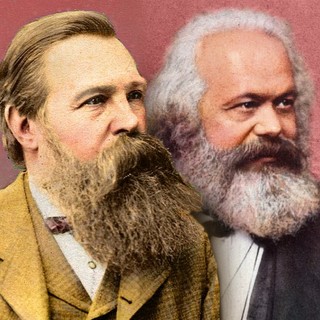A hand-colored colorized photo of Karl Marx and Friedrich Engels. The portrait of Engels is in the foreground and Marx is in the background. They both have large beards. Their facial expressions convey an interesting combination of intensity and whimsy. Year: 1872~1877. Source: https://commons.wikimedia.org/wiki/File:Portraits_of_Marx_and_Engels_handcolored.jpg#/media/File:Portraits_of_Marx_and_Engels_handcolored.jpg