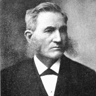 A gray-scale photograph of Lester F. Ward in a suit. He has neatly coifed gray hair and absolutely massive side-burns that stick out on either side of his head.